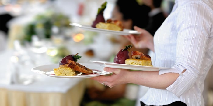 waitress wearing white sleevs serving meals