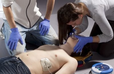 A woman using Alsco defibrillator