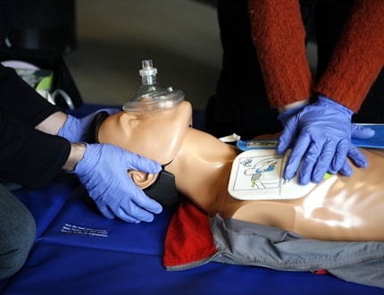 Two individuals performing CPR training