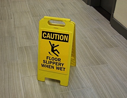A wet and slippery floor warning sign