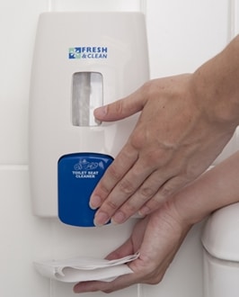 person dispensing toilet seat sanitiser