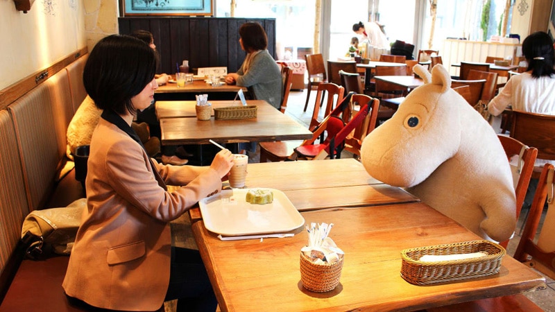 how to create a restaurant business plan Japanese woman dining in front of a stuffed animal