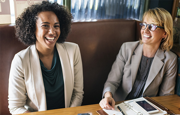 happy women wearing corporate attire