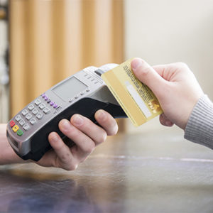 different people holding a credit card and terminal for payment