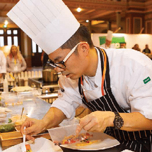 asian chef preparing dish