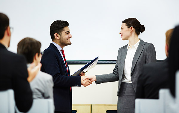 corporate man and woman shaking hands