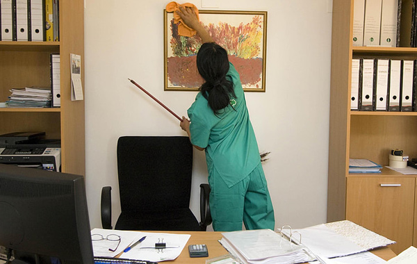 woman cleaning painting inside office