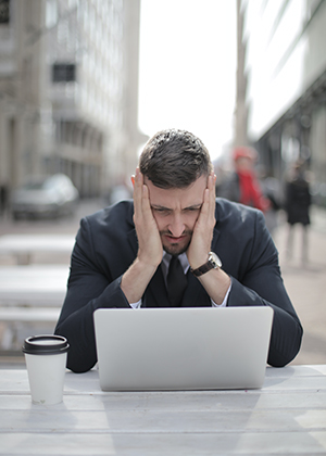 pensive man looking at computer