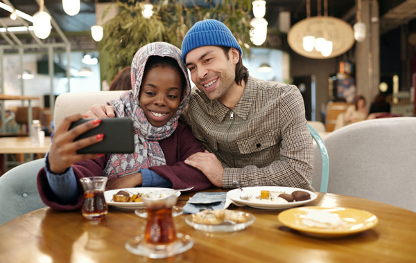 couple talking selfie while eating