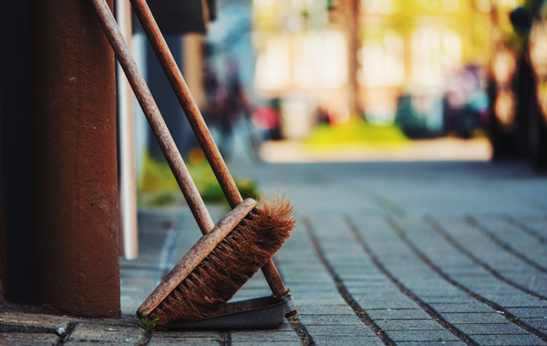 brown push broom on dust pan